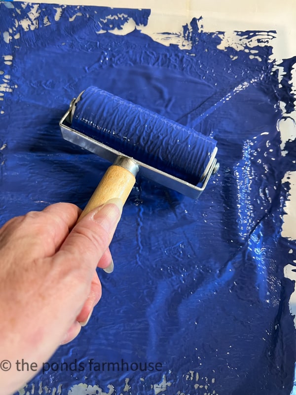 Use a paint roller to flatten the paint.