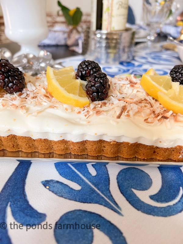 Limoncello Frozen Tart Dessert with coconut and garnish of lemons and blackberries.