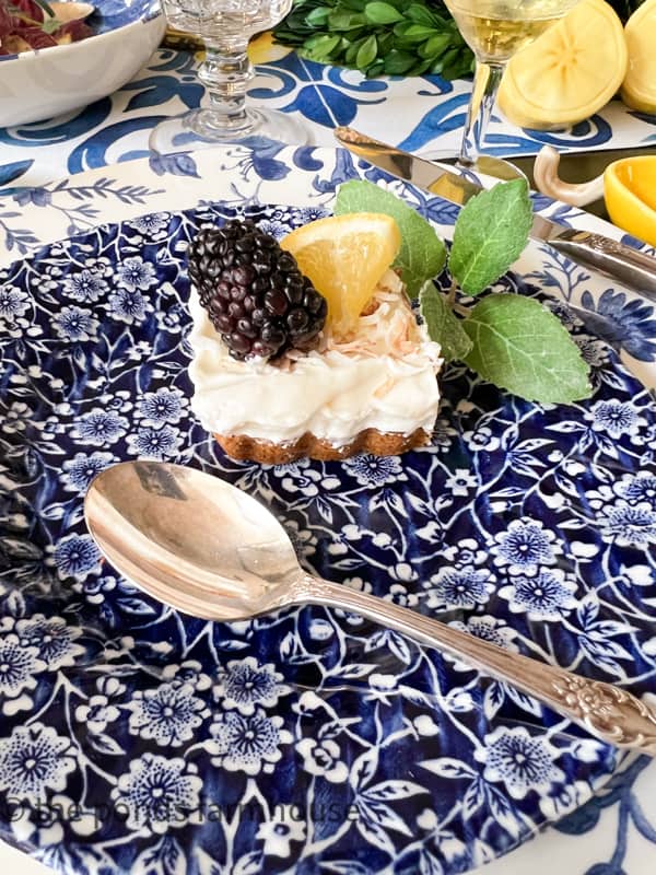 Easy Frozen Limoncello Dessert with toasted coconut. Made in a tart pan and topped with mint, lemon and blackberries