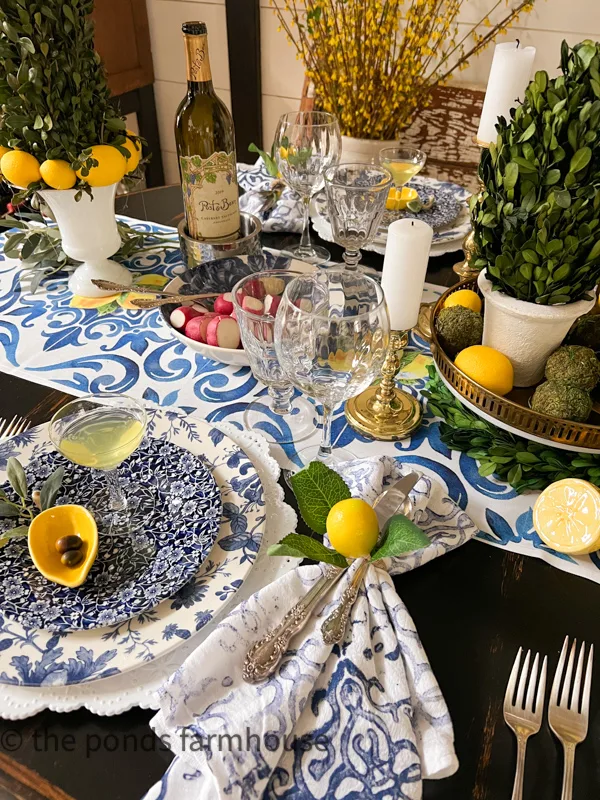 DIY napkins on Italian Table Setting. blue and white dishes, lemon accessories and thrift store tableware.