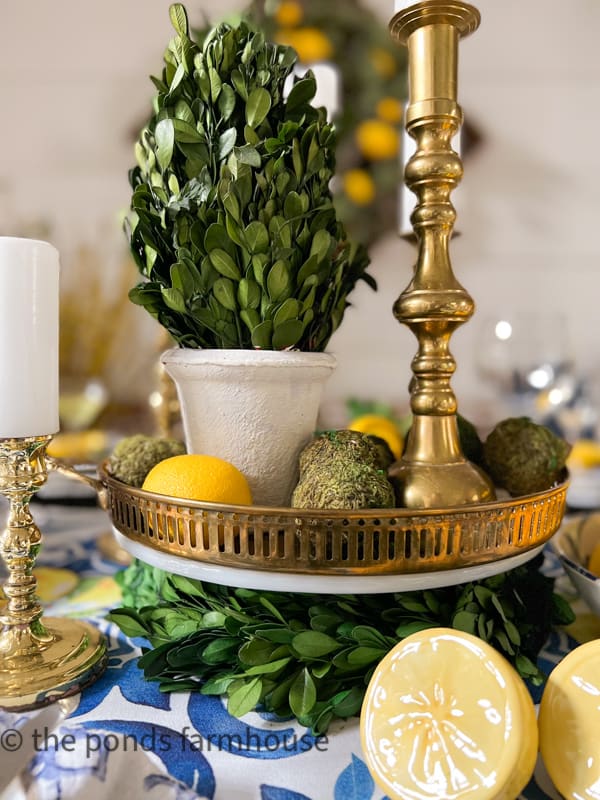 Italian Dinner Table Centerpiece with vintage brass tray, vintage brass candle stick, and boxwood topiary.  