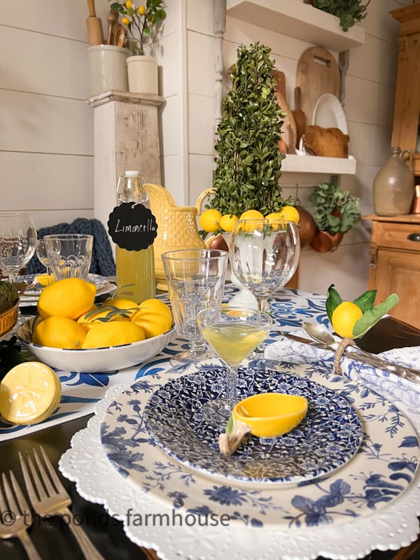 Italian Themed Dinner Table blue and white dishes, lemon accessories and thrift store tableware.  homemade Limoncello 