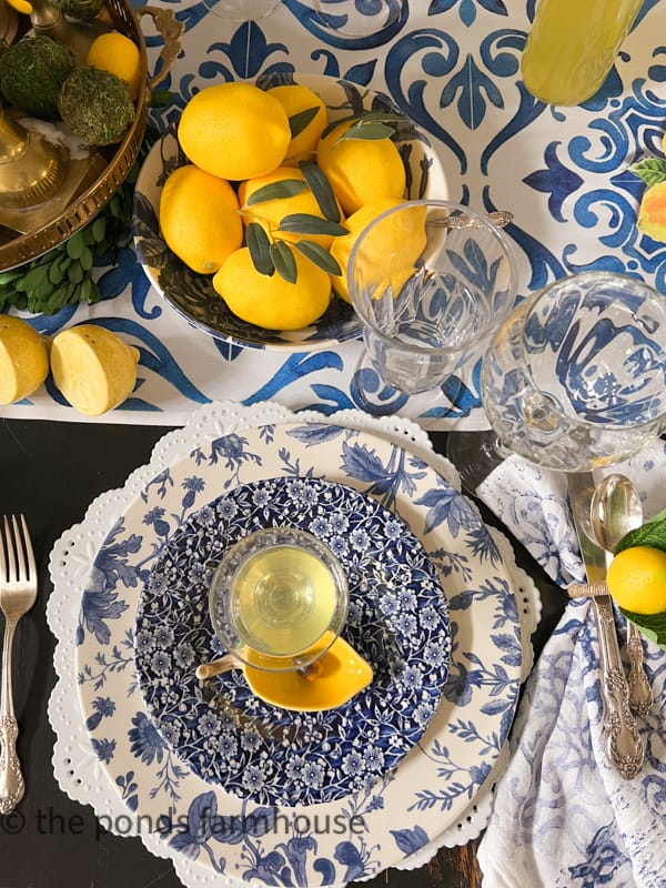 Italian Themed Dinner Table Setting with homemade limoncello and blue and white dishes.  Handpainted flour sack napkins.  