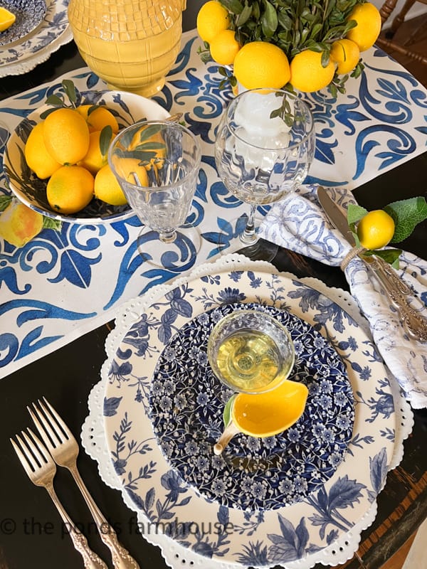 Italian Dinner Party Table Setting for Supper Club with blue and white and lemon accessories.