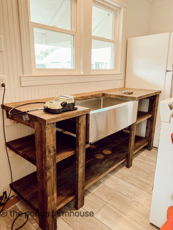 New Sink is installed in the rustic open kitchen cabinets with no doors.  Money saving DIY Beach Cottage remodel