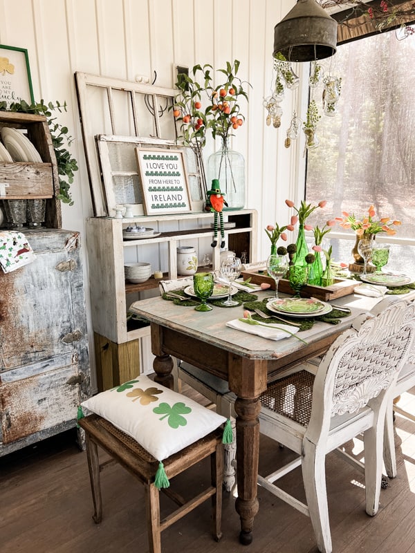 Screened in porch tablescape. Vintage green bottles. St. Patrick’s Day tablescape.