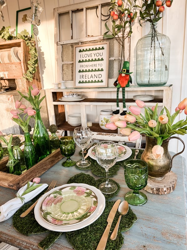 St. Patrick’s Day tablescape, moss table place mats. Floral dinner plates. Vintage tableware in pinks and greens