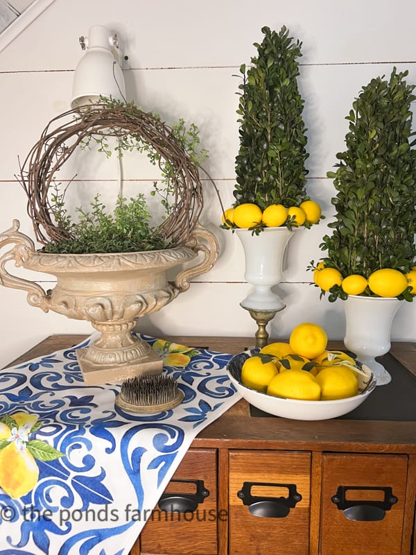 Boxwood Topiaries with lemons on vintage glass vases and DIY grap