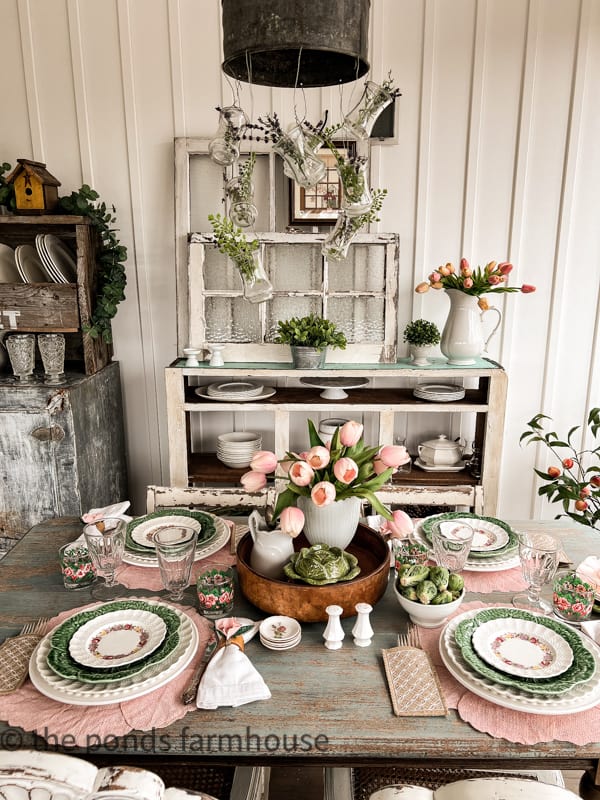 Screened Porch table filled with pin and green for a beautiful table settings for Spring Idea.  