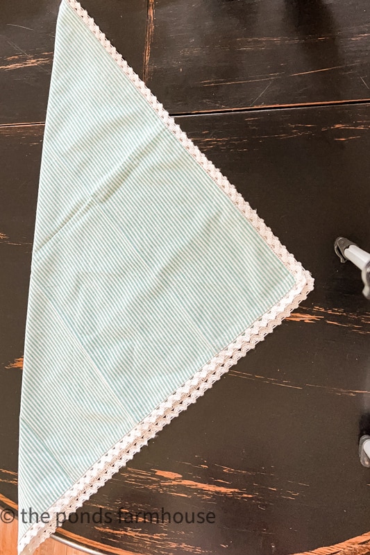 Bow tie napkin fold - fold blue and white strip napkin into a triangle
