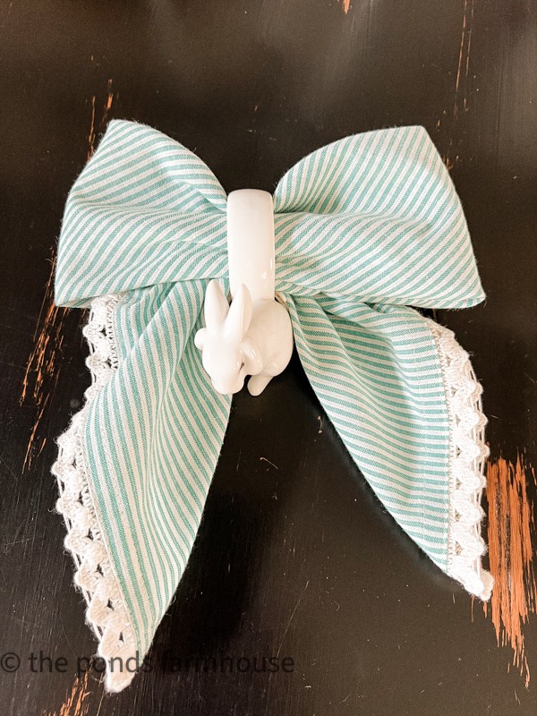 How to fold a napkin into a Bow tie for creative entertaining ideas.  Striped napkin with bunny napkin ring. Tablescape ideas for Spring Tables.