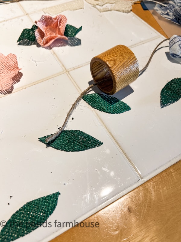 Materials for DIY Napkin rings - wood napkin ring from thrift store, jute twine and burlap flowers and leaves.