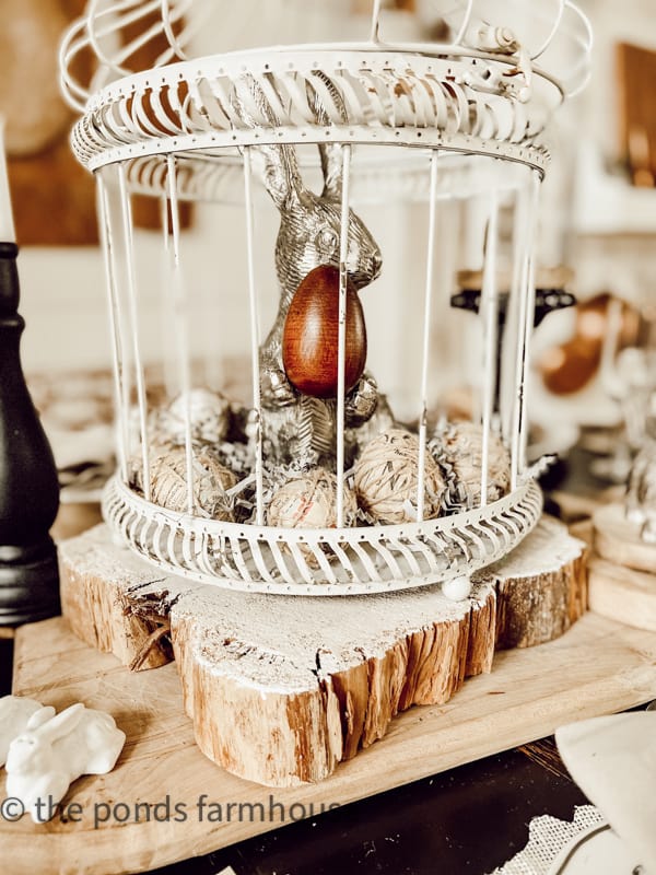 Centerpiece for Easter Brunch Ideas. Thrifted Easter decorations. Pewter Easter bunny and Easter egg in cage.