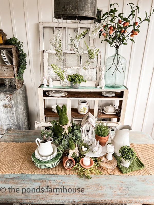 Easter Centerpiece Ideas for your Easter Table Setting. Small vase hanging from light fixture. Using Old windows as background.