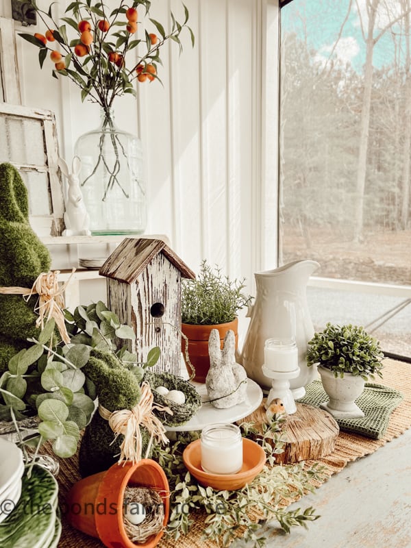 Easter Centerpiece on porch table, Terracotta planters as table decorations. Table Easter bunnies.