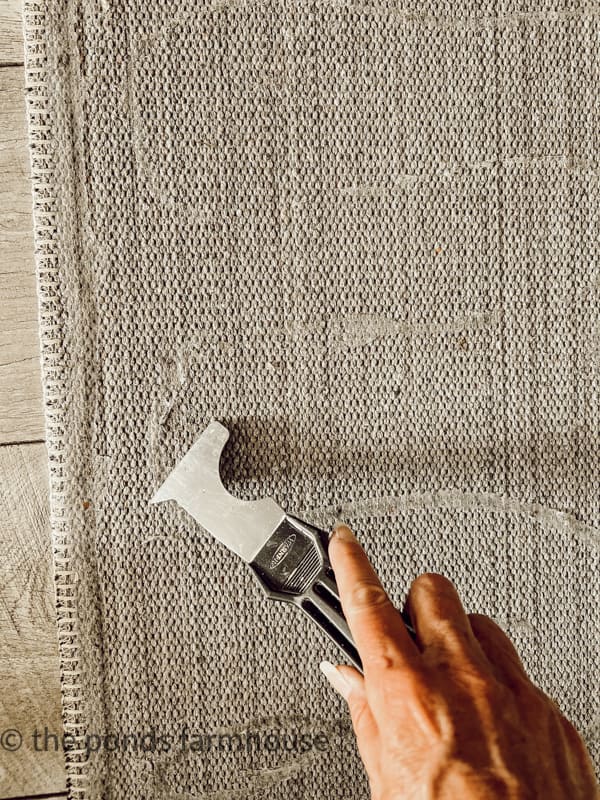 Spread Sealant onto back of rug with a putty knife to make it the rug non slip