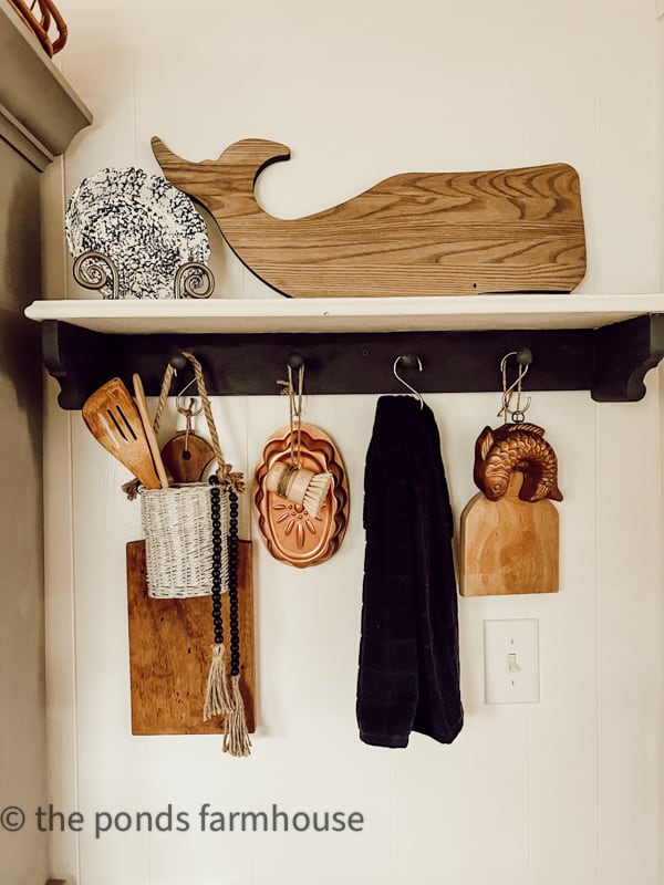 DIY Peg Rail Shelf in Kitchen with vintage copper and cutting boards, charcuterie boards and stoneware.