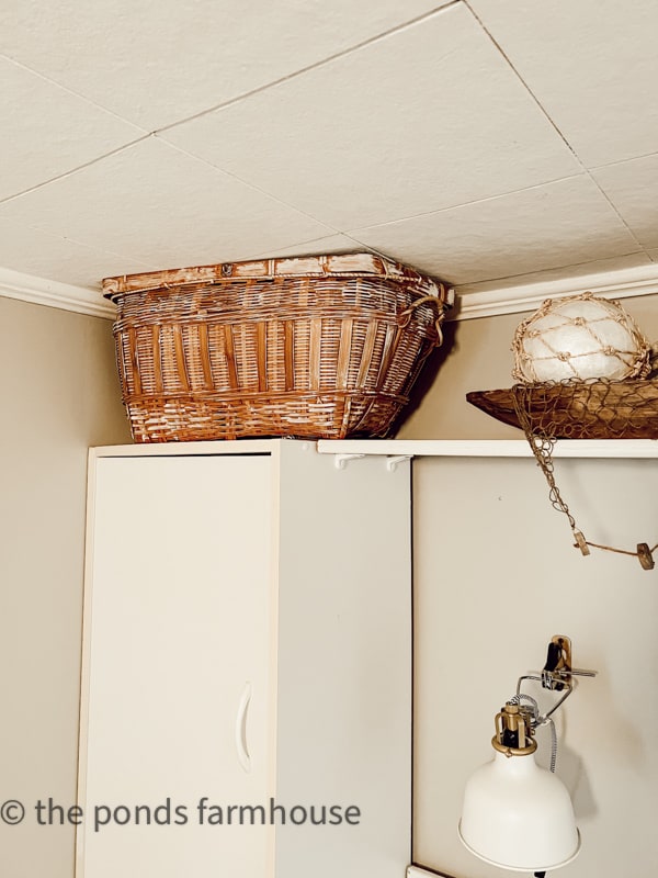 Basket hides unslightly heat duct.  in Tiny House Beach Cottage Remodel.  