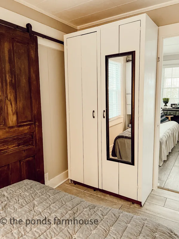 Handcrafted armoire provides lots of storage for a small bedroom. Tiny bedroom remodel storage solutions.