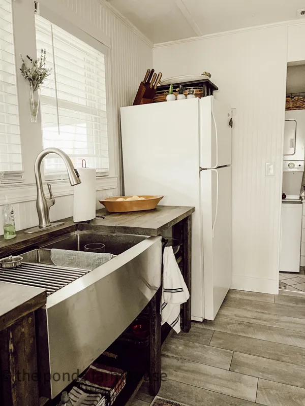 Open cabinet in the tiny kitchen.  1940s Beach Cottage renovations and tiny house ideas to live large.