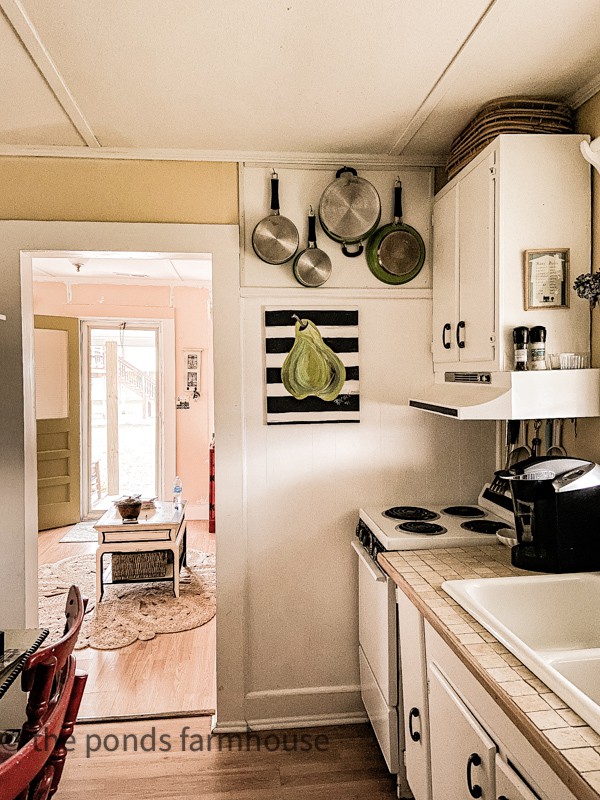 Before photo of kitchen in tiny house before the half wall was removed.  