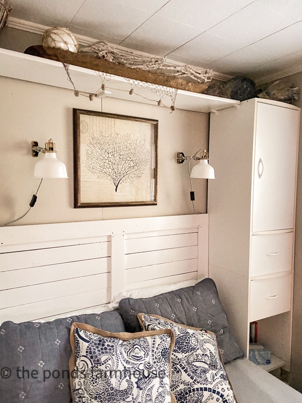 Small Bedroom remodel ideas for a tiny house with built-in storage units surrounding the bed with wall sconce lighting.