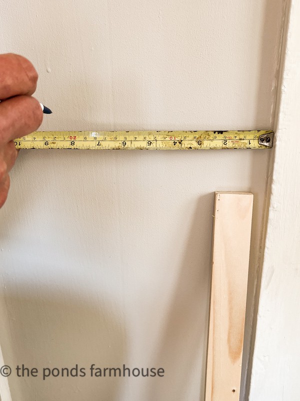 how to add an inexpensive, easy wood accent wall to your home. Measure placement of wood strips.