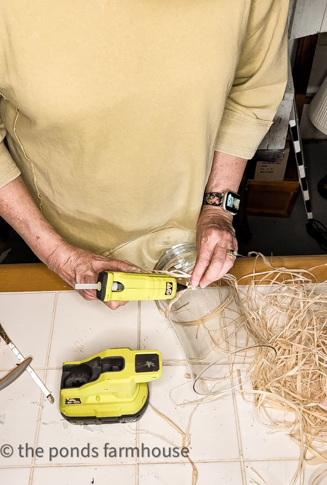 Raffia attached to vase using Ryobi hot glue gun for Pottery Barn hack. Easy DIY.