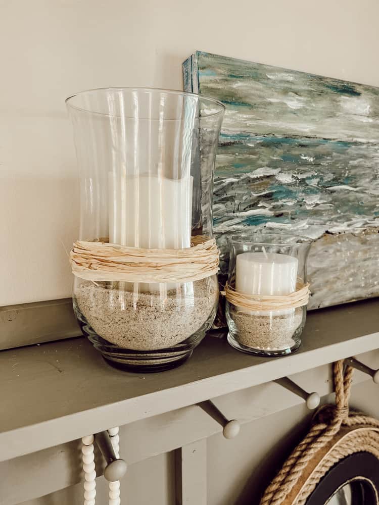 Two thrifted vases used in Pottery Barn hack. Used raffia, sand and candles.