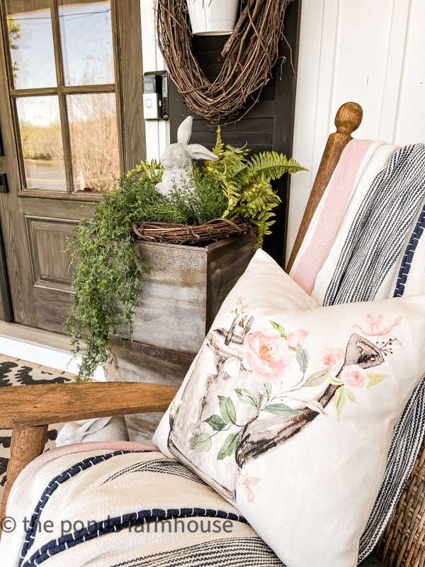 Rocking chair holds a spring throw blanket and spring pillow.  