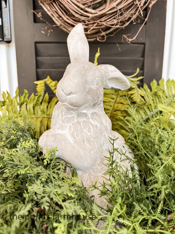 Concrete bunny in planter with repurposed shutters.