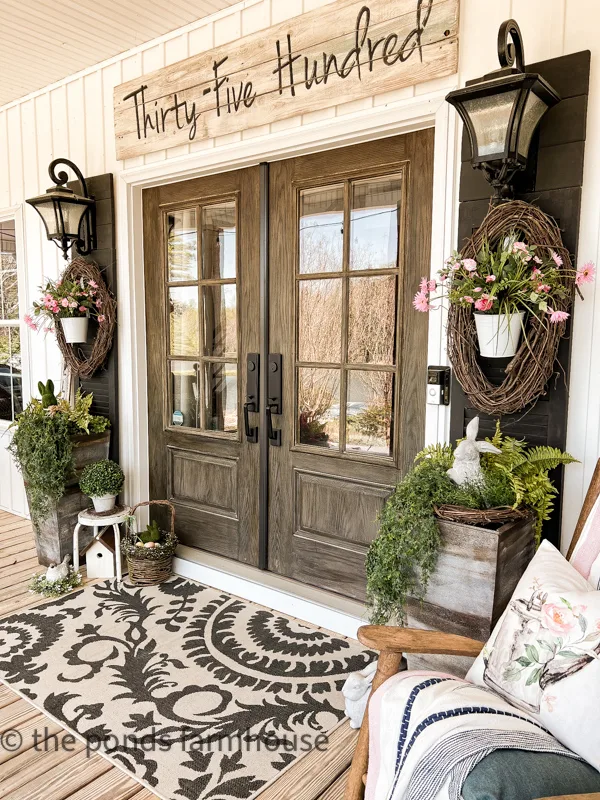 Farmhouse front porch decorated for Spring with bunnies and florals