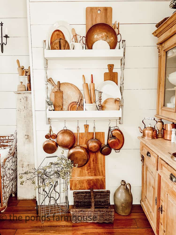 DIY Plate Rack filled with vintage breadboards, rolling pins vintage copper and ironstone.