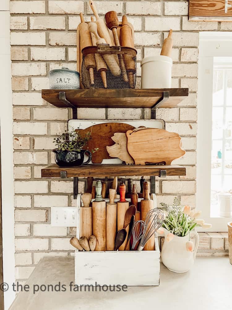 Open Shelves in Kitchen with vintage rolling pins, cutting boards shaped like pigs and old crocks