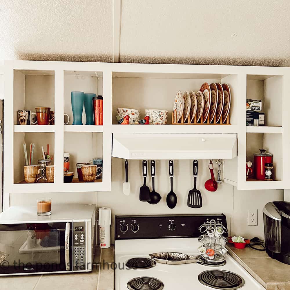 All cabinet doors have been removed for open shelving in guest cottage.  Shelves hold dinnerware and cups