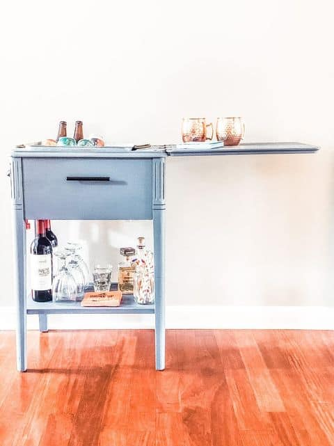 Vintage sewing table converted into bar cart. Old sewing table bar cart. Repurposed furniture and upcycled Decorating ideas