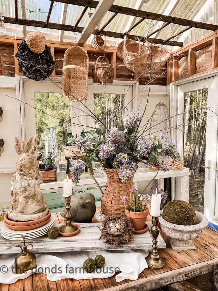 Easy Basket Centerpiece decorating ideas. Baskets hanging in DIY Greenhouse.