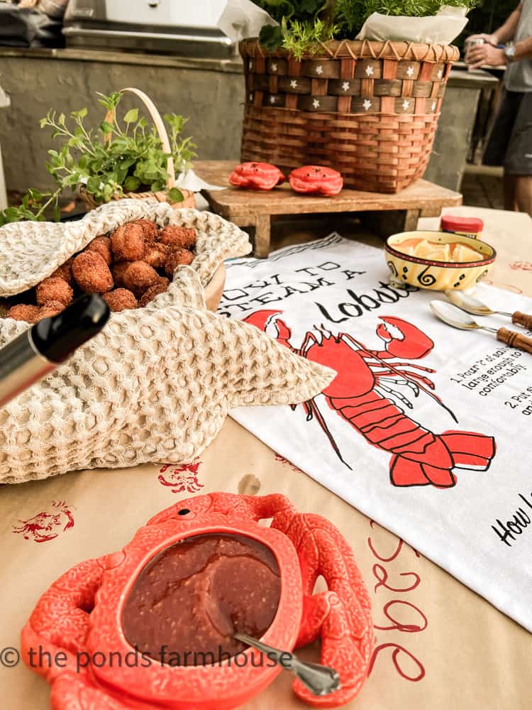 Buffet style table for sides and condiments at Low Country Boil Party, patriotic basket, unique crab salt and pepper shakers.