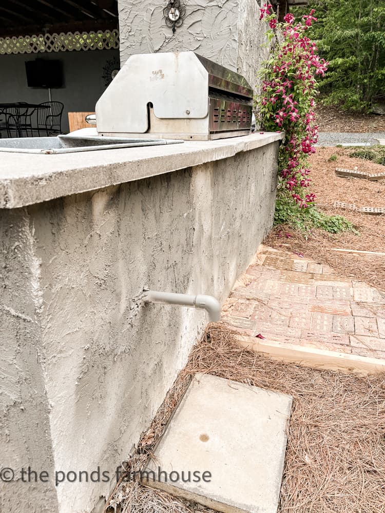 place bucket under drain when dumping