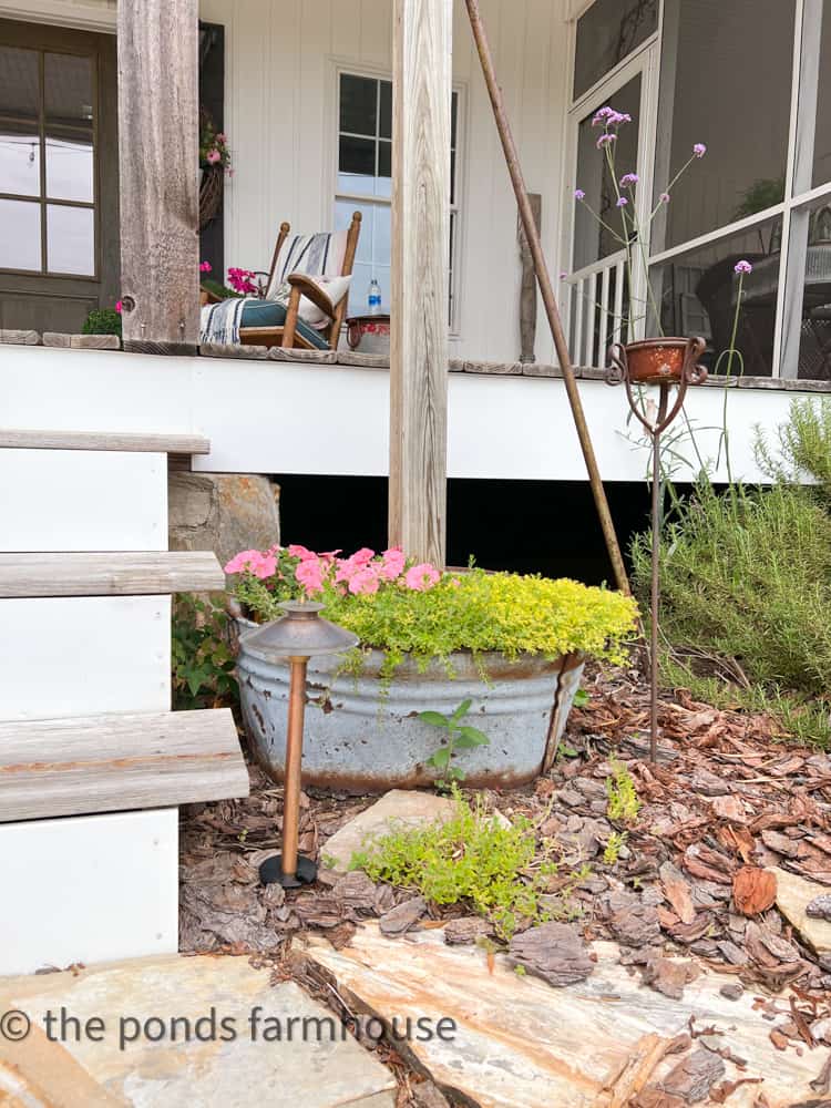 Planters beside the front porch.  Galvanized Planter, post in galvanized planter