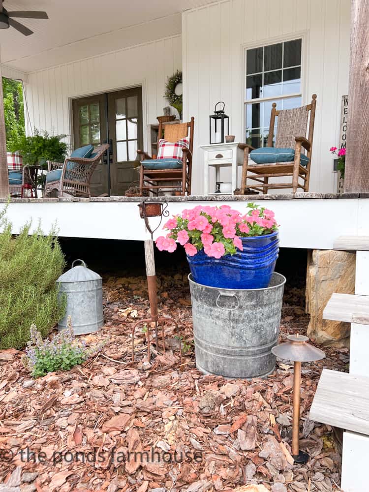 Add a planter to a bucket to elevate the height beside the front porch. Galvanized bucket. Galvanized gas can.