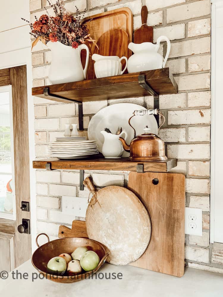 Add open shelving to create rustic charm to a modern farmhouse. Shelves filled with ironstone & copper.