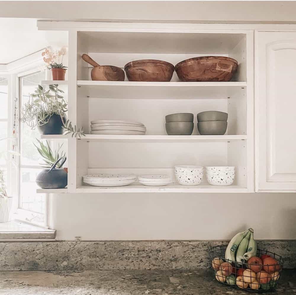 Remove cabinet doors for a cubby shelve.  Filled with bowls, plates and wooden bowls