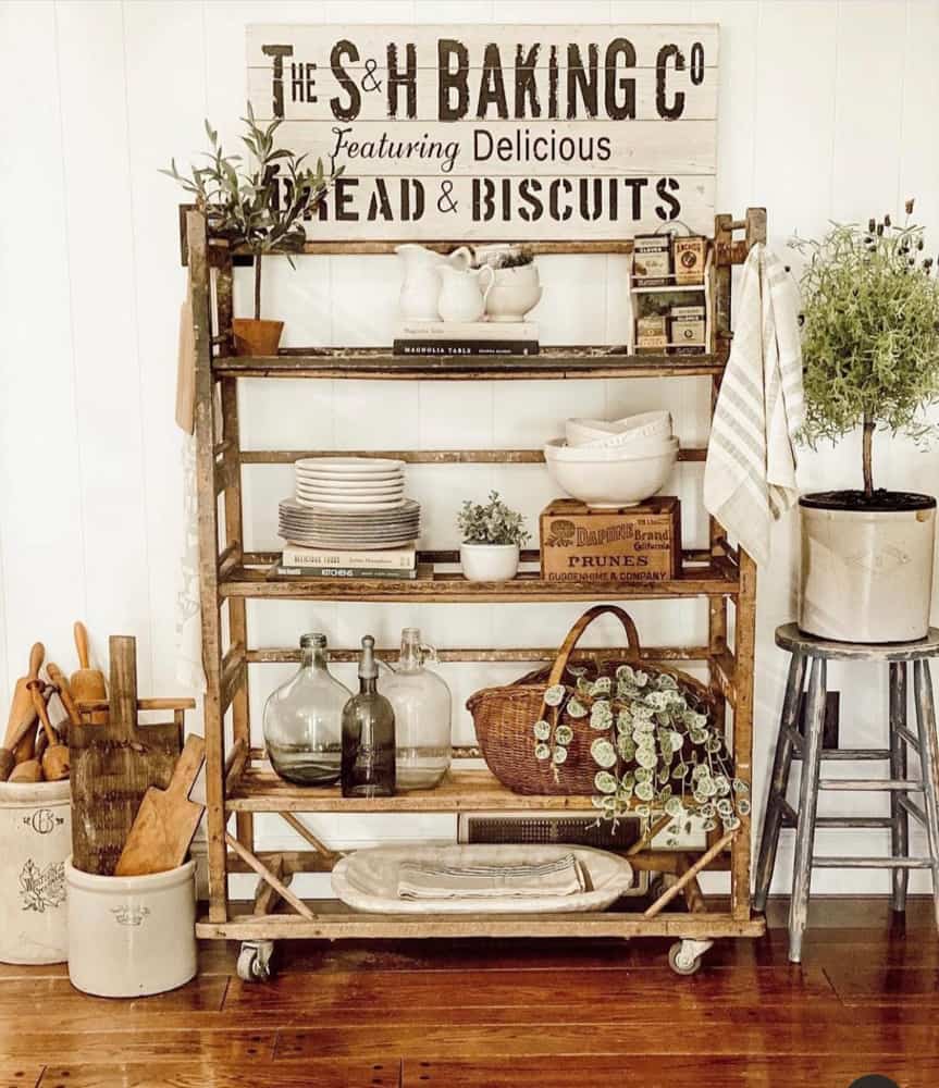 Bakers Rack with vintage collections of ironstone, baskets, wooden boxes and old crocks.