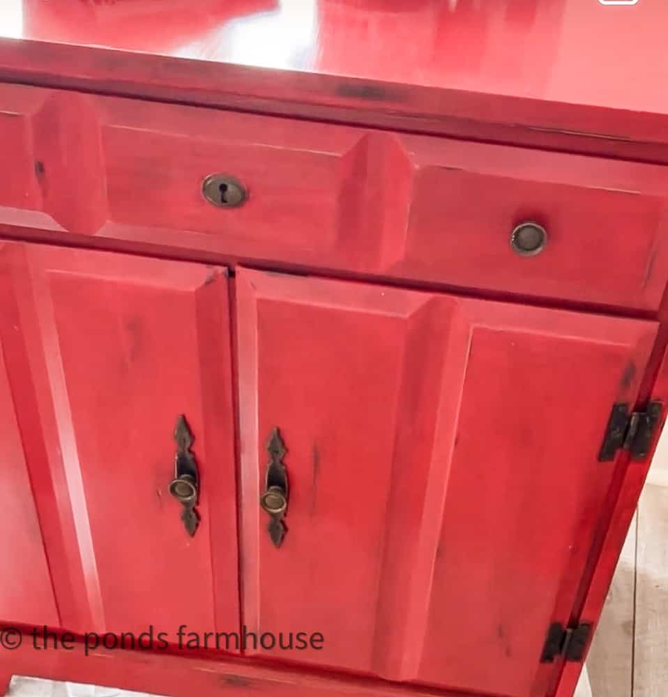 Storage cabinet before with red paint.  