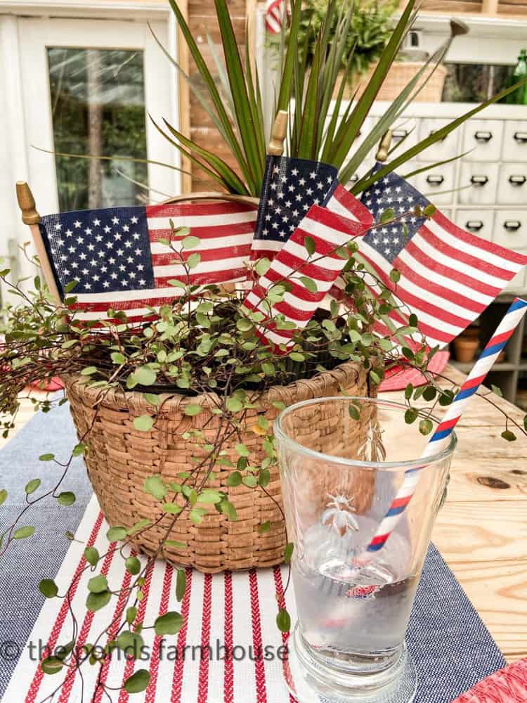 Thrift Store Find basket of greenery and flags for a patriotic tablescape. 