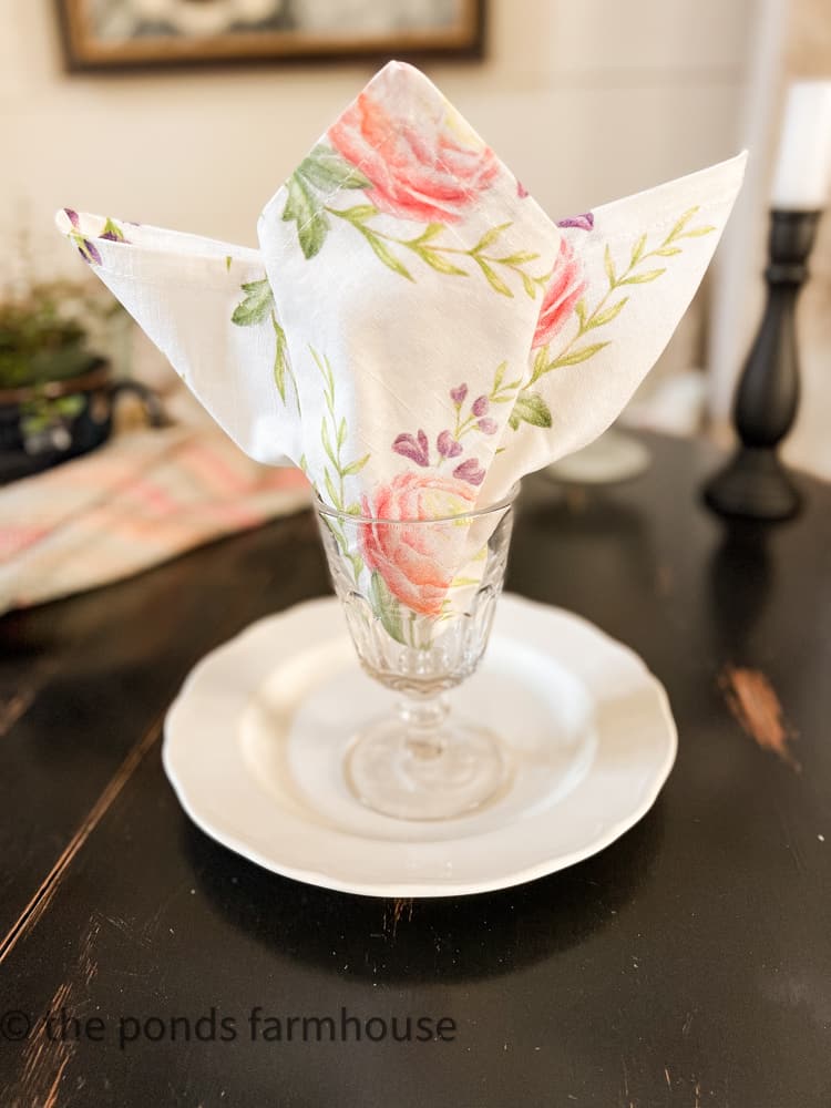 Tulip Napkin Fold in water goblet, unique tulip shape folded napkin for a festive summer tablescape.