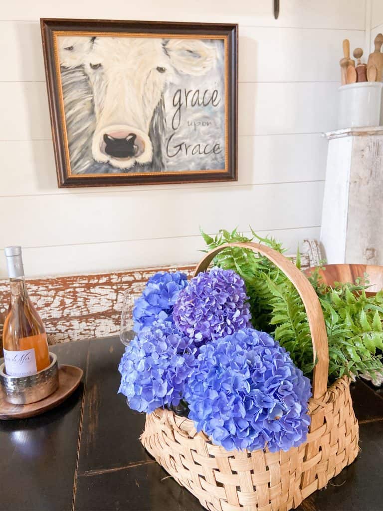 Handmade Basket filled with blue hydrangeas for table centerpiece in Farmhouse.