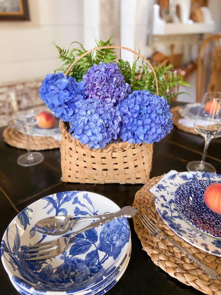 Summer Tablescape with basket of hydrangeas for country chic summer table centerpiece.