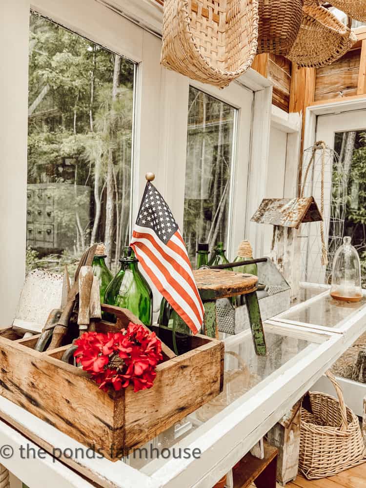 Greenhouse and She Shed Decorated for 4th of July with flags.